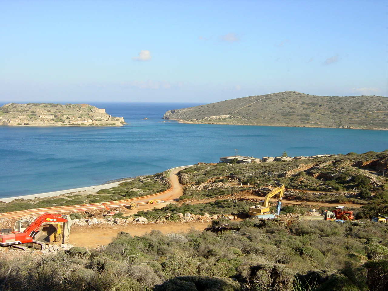 Building permits in Crete – coastal site preparation with excavators near Elounda, managed by Zervos Consulting Engineers